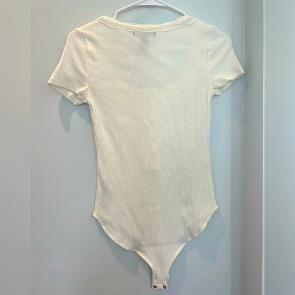 Forever 21 bodysuit with white floral pattern around neck. - Picture 2 of 5